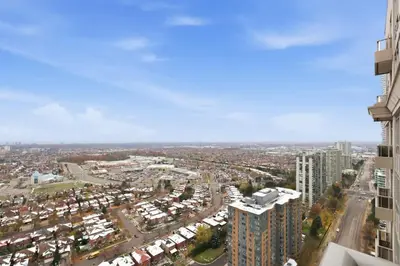 an aerial view of a city with tall buildings at Stylish 3br Condo - Parking - 65 TV in Mississauga