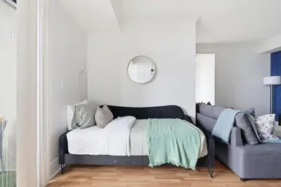 a bedroom with a bed and a chair at Stylish 3br Condo - Parking - 65 TV in Mississauga