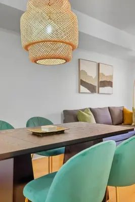 a dining room with a wooden table and chairs at Tropical Designer King Suite - Sleeps 5 - Parking in Mississauga