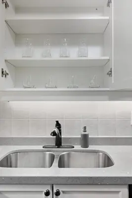 a kitchen sink with a faucet on top of it at Tropical Designer King Suite - Sleeps 5 - Parking in Mississauga
