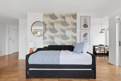 a bedroom with a large bed and a mirror at Elegant 2BR Sky Condo for 9 - Terrace - Lake Views in Mississauga