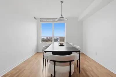 a dining room with a table and chairs and a window at Elegant 2BR Sky Condo for 9 - Terrace - Lake Views in Mississauga