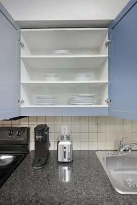 a kitchen with a counter top with a sink and a counter top at Designer 2BR - King Suite - Rare 2 Parking - YYZ in Mississauga