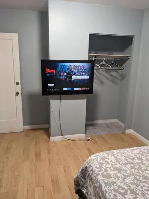 a room with a flat screen tv on a wall at Private Room In Hamilton 2 in Hamilton
