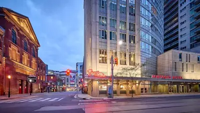an empty street in a city with tall buildings at The Vicky - Centre of Attention - Location Design in Toronto