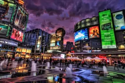 a crowd of people in a city at night at The Vicky - Centre of Attention - Location Design in Toronto