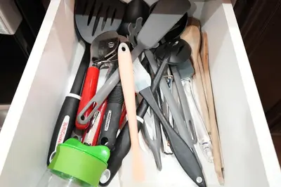a drawer filled with knives and utensils at Luxury 5BR Home with Spa Bath in Burlington