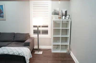 a living room with a couch and a window at Luxury 5BR Home with Spa Bath in Burlington