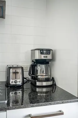 a coffee maker sitting on a counter next to a toaster at Lake view Studio Condo High Floor Downtown Toronto in Toronto