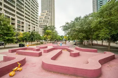 a park with pink benches in the middle of a city at Private Entrance 2 Bedroom Condo Downtown Toronto in Toronto
