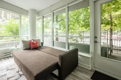 a bench in a room with windows in a room at Private Entrance 2 Bedroom Condo Downtown Toronto in Toronto