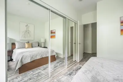 a bedroom with a bed and a glass wall at Private Entrance 2 Bedroom Condo Downtown Toronto in Toronto