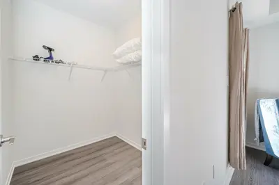 a room with white walls and a wooden floor at Centrally Located 3-Bedroom Townhouse in Vaughan in Vaughan