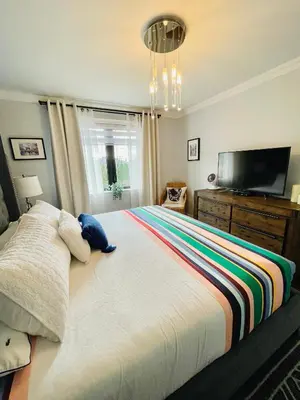 a bedroom with a large bed with a teddy bear on it at Beautiful Home with Hot tub by YYZ, 20min to CN Tower in Toronto