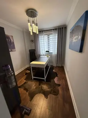 a room with a table in the middle of a house with a large puddle at Beautiful Home with Hot tub by YYZ, 20min to CN Tower in Toronto