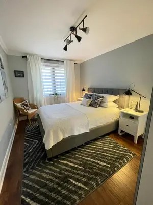 a bedroom with a large bed and a rug at Beautiful Home with Hot tub by YYZ, 20min to CN Tower in Toronto