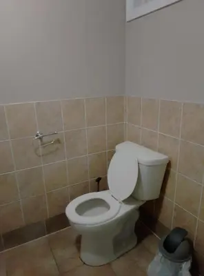 a bathroom with a white toilet in a room at Central Location New Year Stay- Free Parking & Fast Wifi in Kitchener