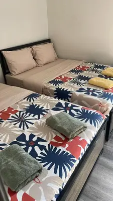 two beds sitting next to each other in a bedroom at Cost Effective Stay in Core Downtown Queen-King St-Self Checkin & Free Wifi in Toronto