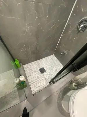 a bathroom with a tile floor and a toilet at Cost Effective Stay in Core Downtown Queen-King St-Self Checkin & Free Wifi in Toronto