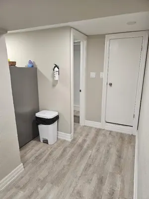 an empty room with a door and a trash can at Superb Guest House In Downtown-Self Checkin& Fast Wifi in Toronto