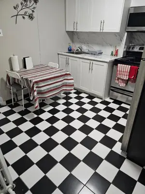 a kitchen with a black and white checkered floor at Superb Guest House In Downtown-Self Checkin& Fast Wifi in Toronto