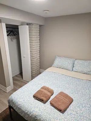 a bedroom with a bed with two towels on it at Superb Guest House In Downtown-Self Checkin& Fast Wifi in Toronto