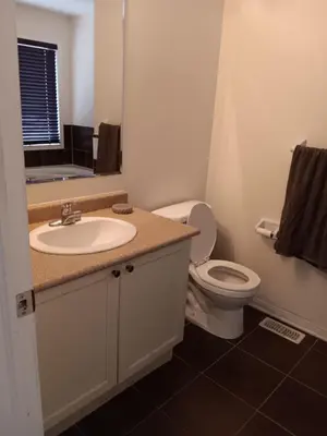 a bathroom with a sink and a toilet at House near Toronto Pearson Airport in Brampton