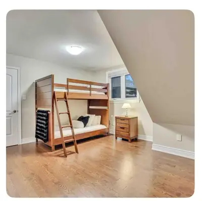 a bedroom with a bunk bed and a desk at Riverside Dreams in Wasaga Beach