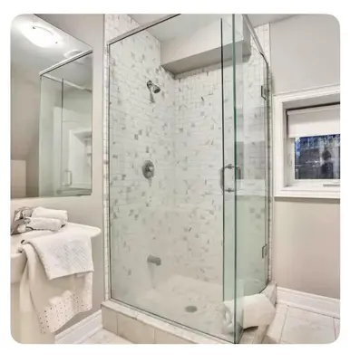 a bathroom with a glass shower with a sink at Riverside Dreams in Wasaga Beach
