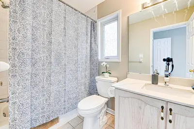 a bathroom with a toilet and a sink and a shower at The Urban Family Pad in Toronto