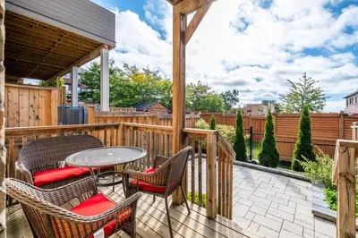 a patio with chairs and a table on a deck at Spacious Toronto Home Near High Park and Yorkdale Mall in Toronto
