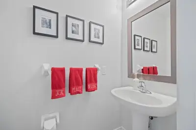 a bathroom with a sink and a mirror and red towels at Spacious Toronto Home Near High Park and Yorkdale Mall in Toronto