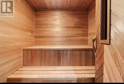 a sauna with wooden walls and a wooden floor at Luxurious home in Belleville in Belleville