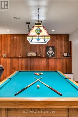 a pool table in a room with a ceiling at Luxurious home in Belleville in Belleville