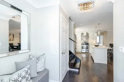 a kitchen and living room with white walls and a door at Beautiful 3 bed 2 bathroom home Toronto in Toronto