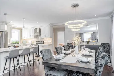 a kitchen with a table with chairs and a chandelier at Beautiful 3 bed 2 bathroom home Toronto in Toronto