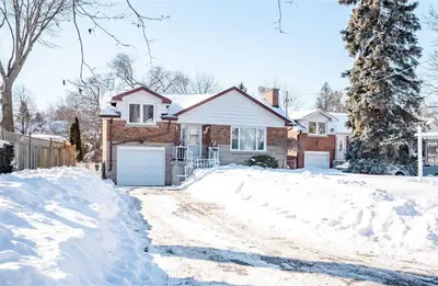 a house with a driveway covered in snow at Beautiful 3 bed 2 bathroom home Toronto in Toronto