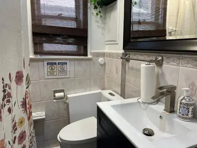 a bathroom with a white toilet and a sink at Private Room with Shared Bathroom in West-Toronto in Toronto