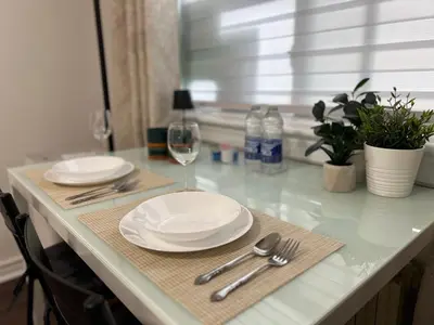 a table with two plates and a glass of wine at Private Room with Shared Bathroom in West-Toronto in Toronto
