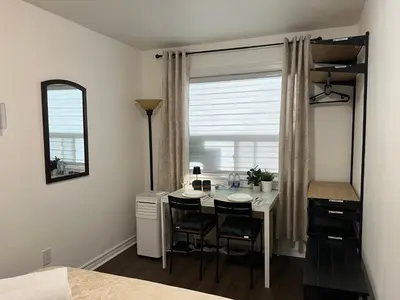 a room with a table with chairs and a window at Private Room with Shared Bathroom in West-Toronto in Toronto