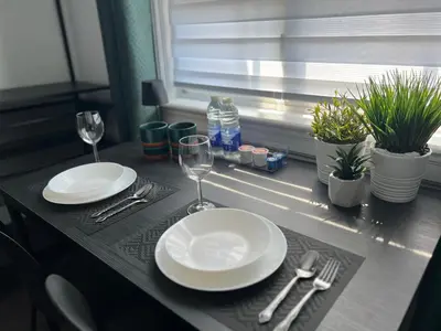 a table with two white plates and wine glasses at Private Room with Shared Bathroom in West-Toronto in Toronto