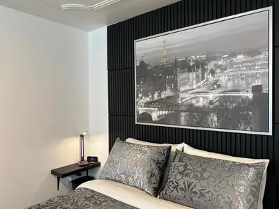 a bedroom with a bed with a picture on the wall at Private Room with Shared Bathroom in West-Toronto in Toronto