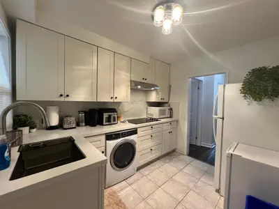 a kitchen with white cabinets and a white refrigerator at Private Room with Shared Bathroom in West-Toronto in Toronto