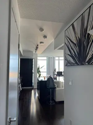 a living room with a couch and a table at 1 bedroom condo by lakeshore in Toronto