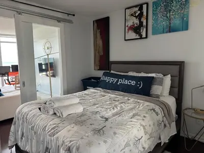 a bedroom with a bed with two towels on it at 1 bedroom condo by lakeshore in Toronto
