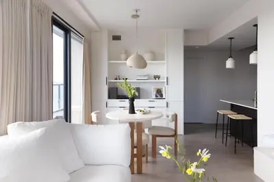 a living room with a white couch and a table at King Suites Toronto Downtown Soho District in Toronto