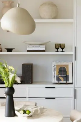 a room with white shelves and a table with a vase at King Suites Toronto Downtown Soho District in Toronto