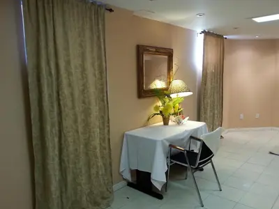 a dining room with a table and a mirror at Maria's Homestay in Thornhill