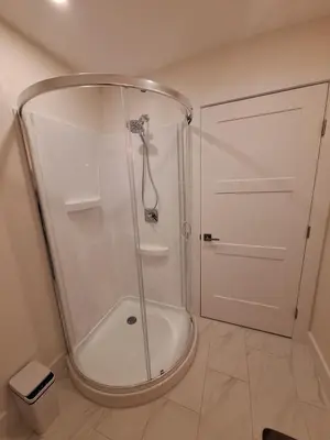 a shower with a glass door in a bathroom at Elderado A-Frame