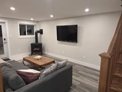 a living room with a couch and a wood stove at Elderado A-Frame